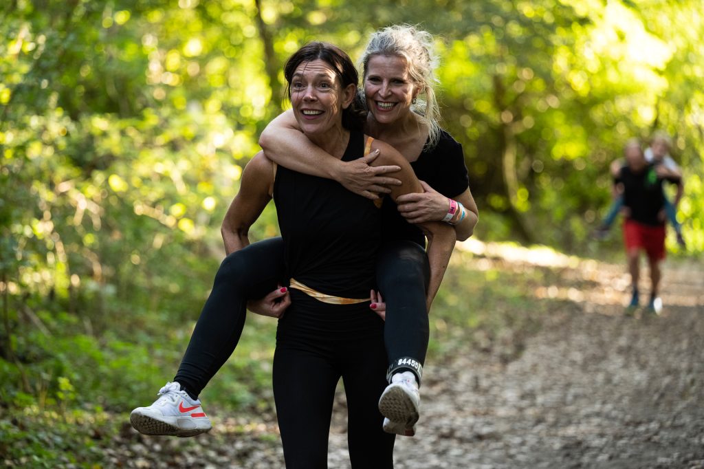 Woman carrying another woman on her back. (photo about preventing blisters, avoiding blisters while running)