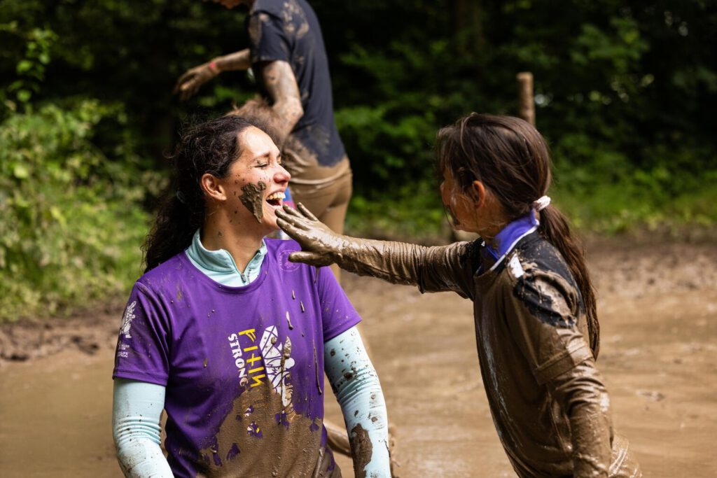 Mother and daughter playing in the mud during strong viking, the most fun family outing