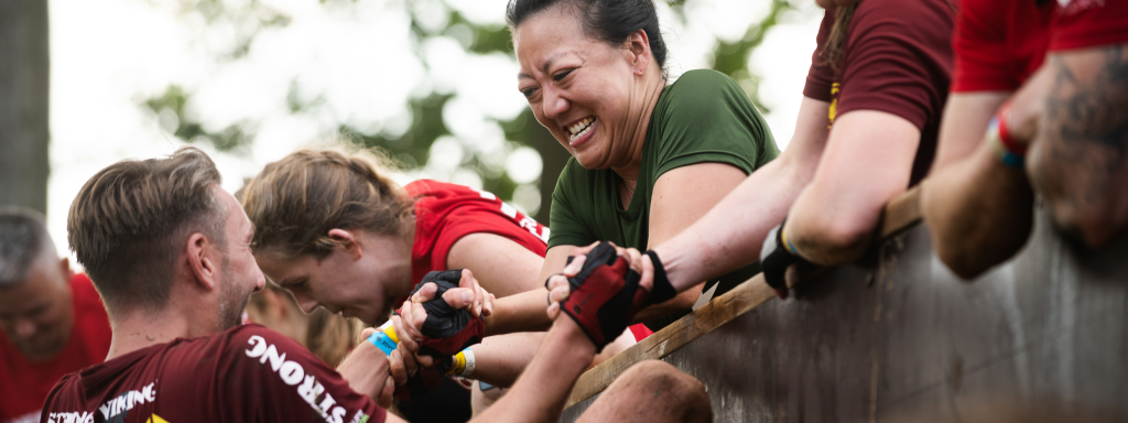 Participants of the Strong Viking obstacle run mud run wearing proper sports gear, such as gloves.