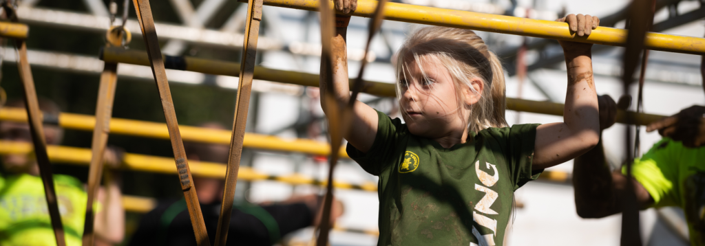 Girl hanging from monkey bars ( fun idea for an active childrens' party in Amsterdam, Ghent, Wijchen, Frankfurt, Nijmegen).