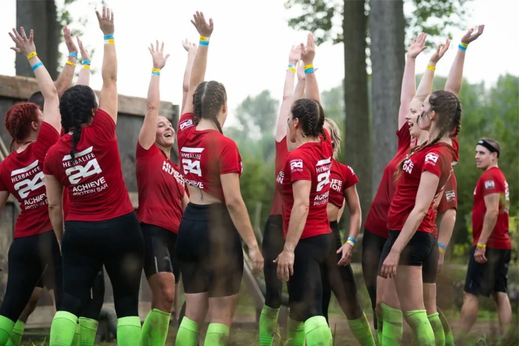 Employee vitality for businesses – The Herbalife team throws their hands in the air during Strong Viking!